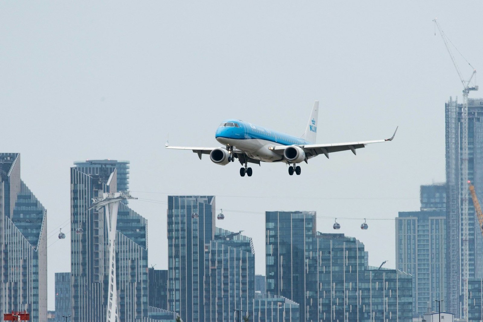 Passenger jet landing at London City Airport past Docklands towers