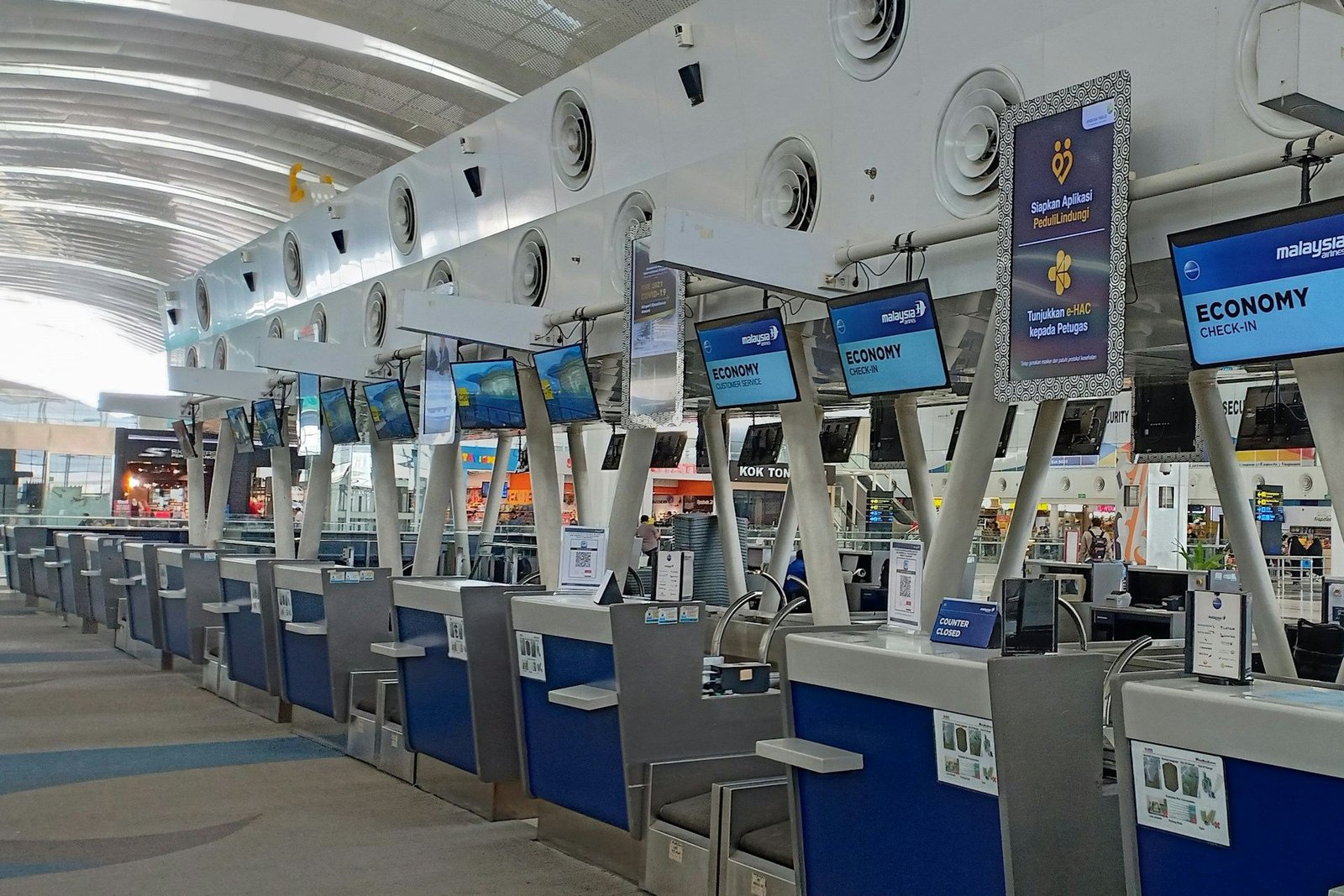 Row of airline check-in desks in an airport terminal