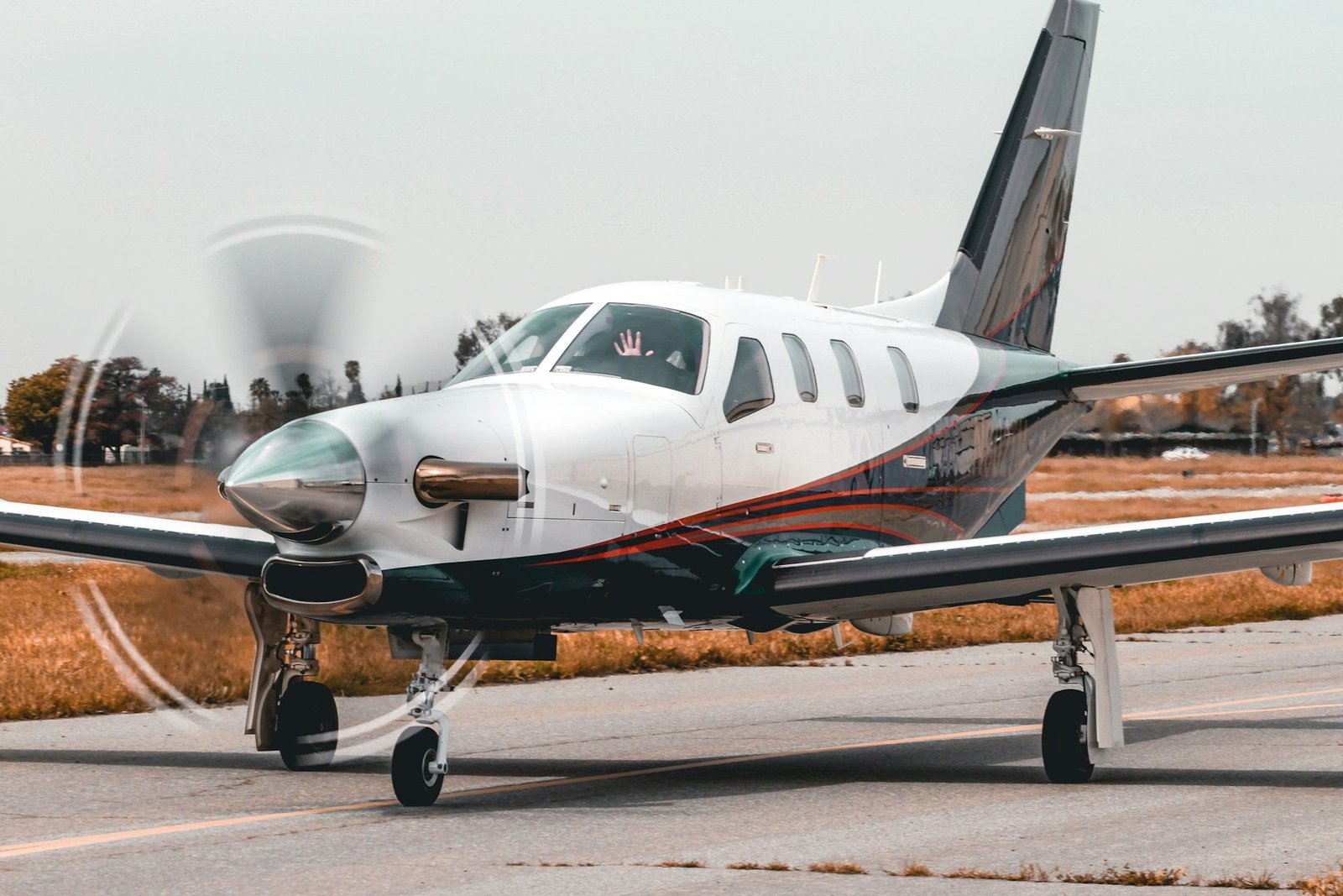 Single-engine turboprop aircraft taxiing on a runway