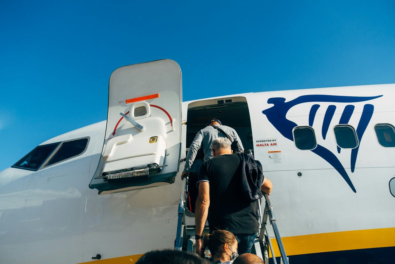 Passengers boarding a Ryanair jet by the front steps