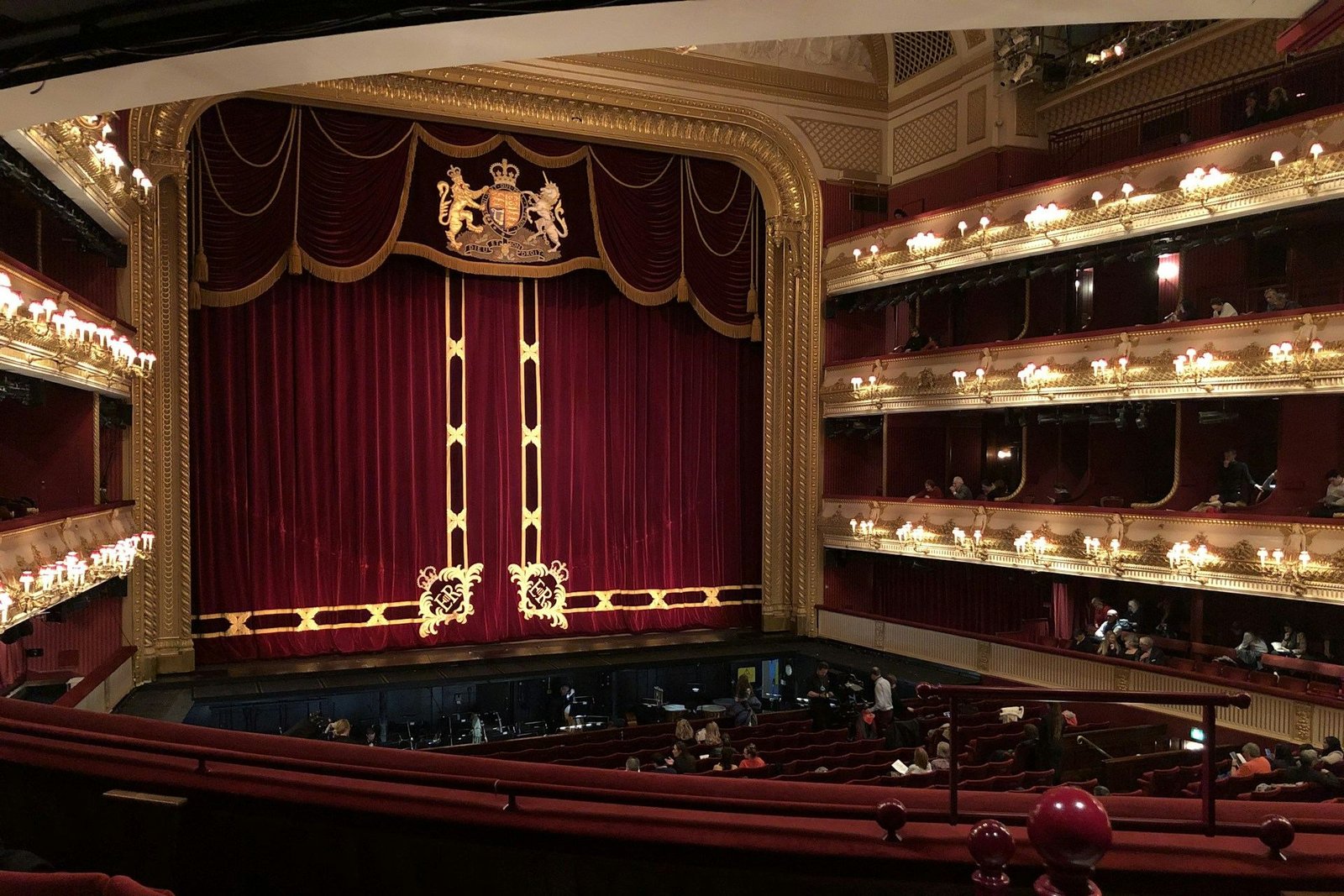 Red velvet stage curtain and gold tiers inside the Royal Opera House