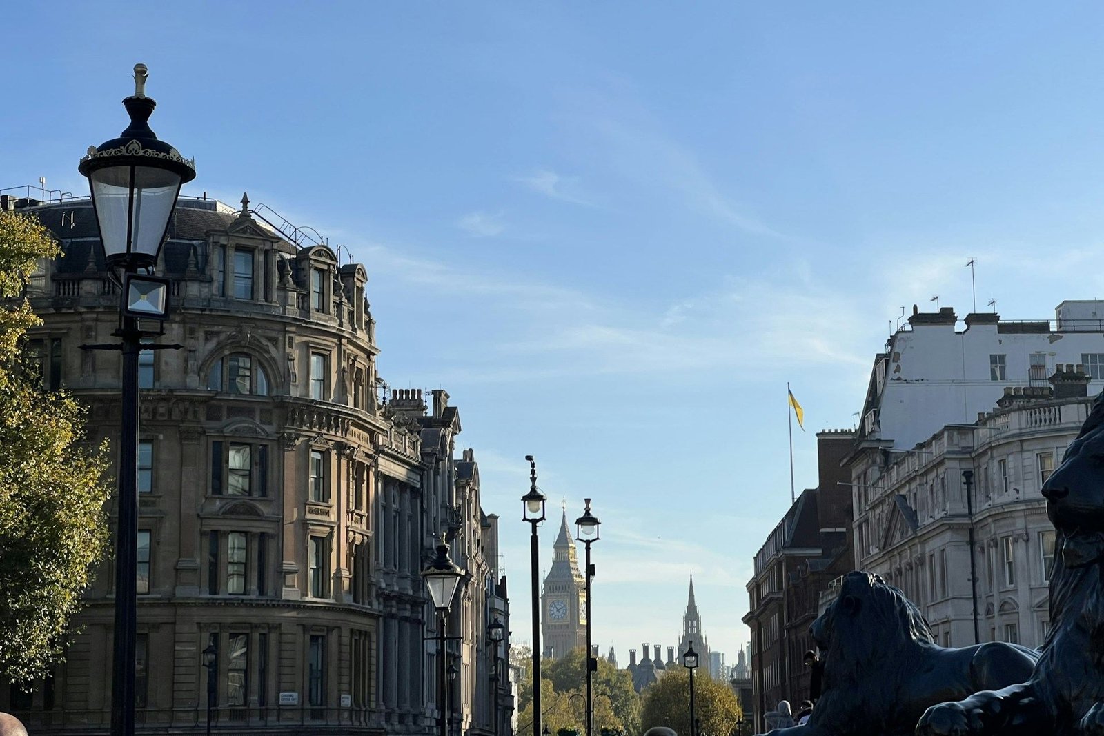London street of grand buildings with Big Ben in the distance