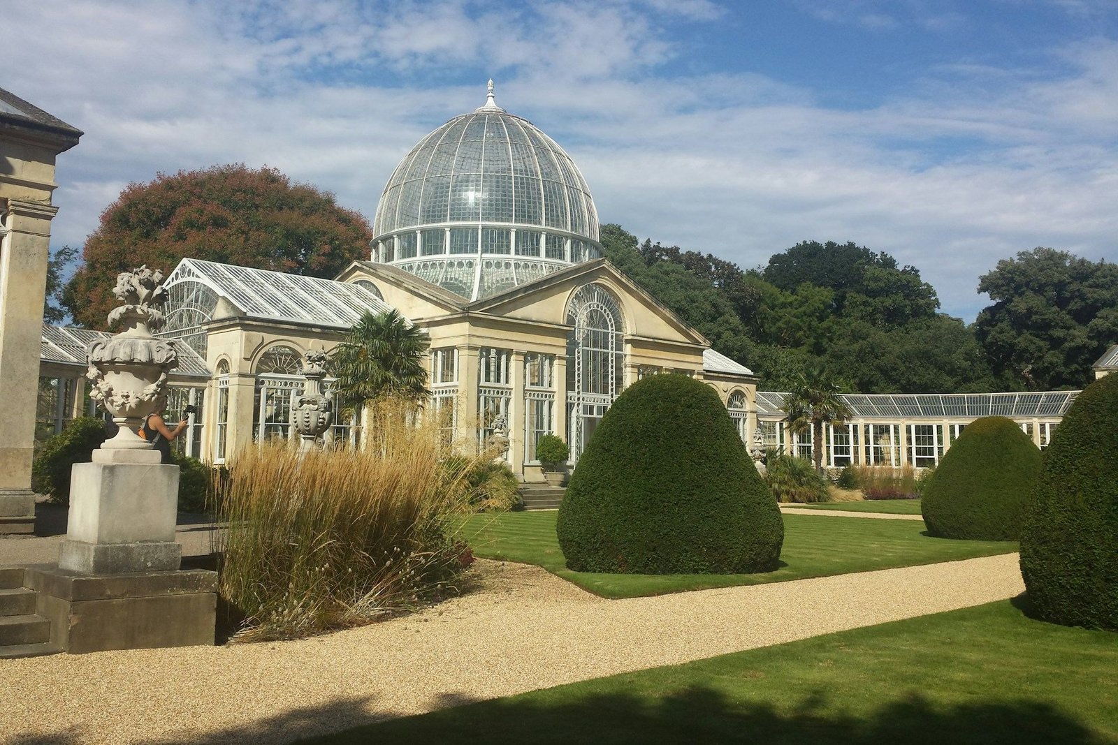 Domed glass conservatory in formal gardens