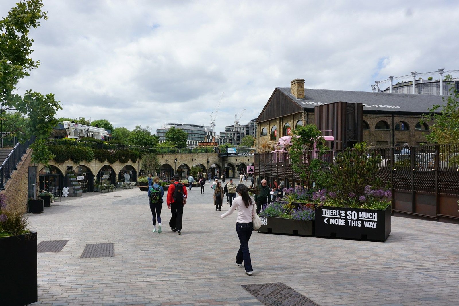 People walking through the paved square at Coal Drops Yard, King’s Cross