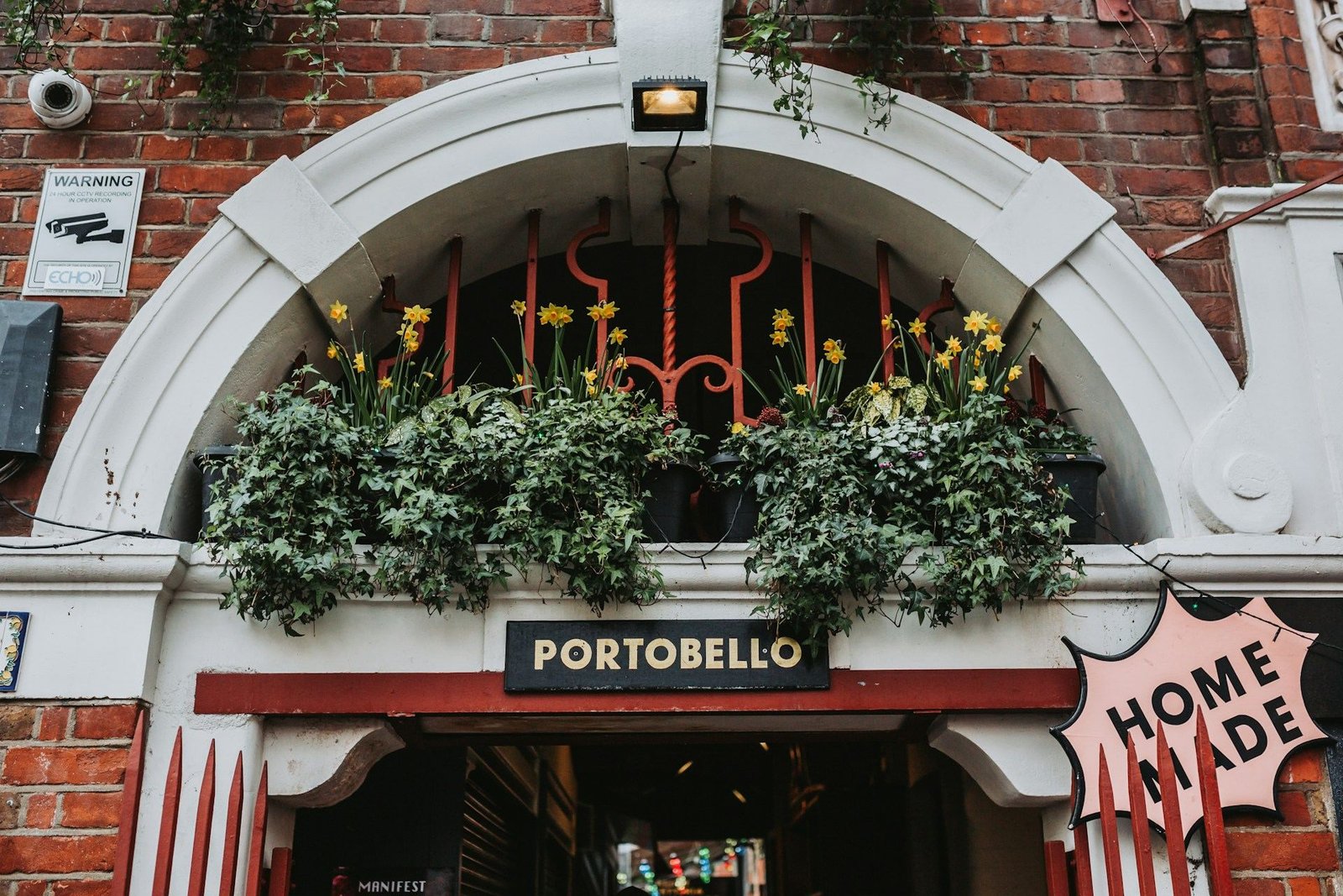 Arched shopfront with window boxes on Portobello Road