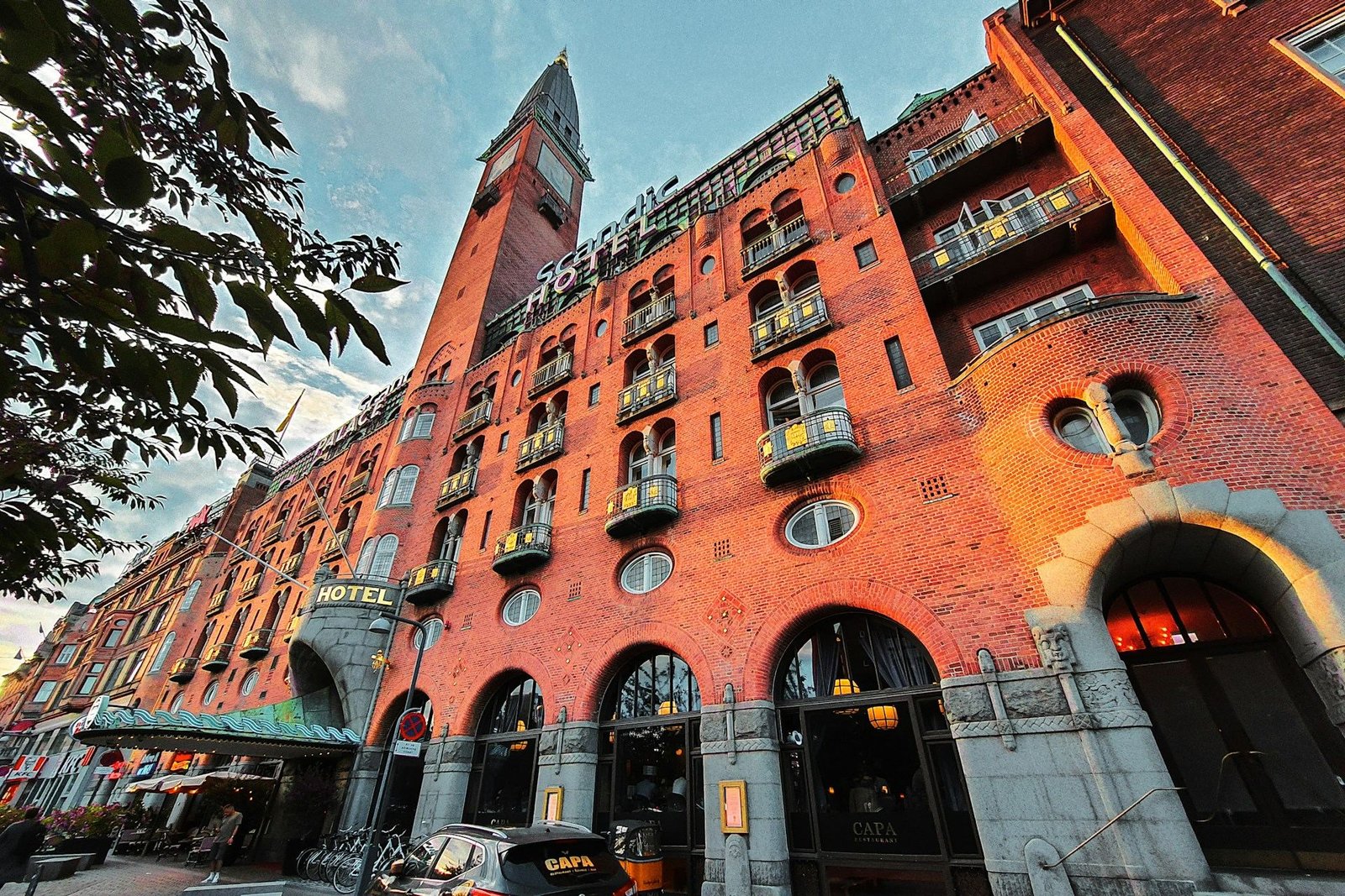 Red-brick Gothic hotel facade with a clock tower