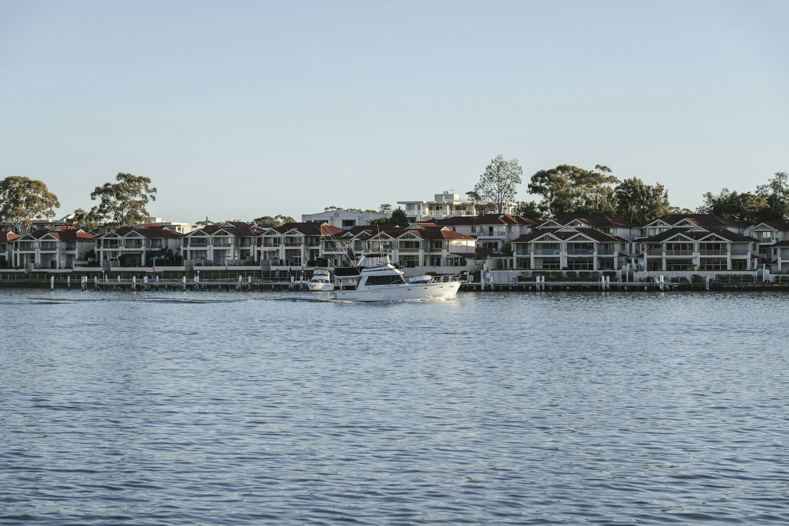 Riverside homes and a motor yacht on the Thames