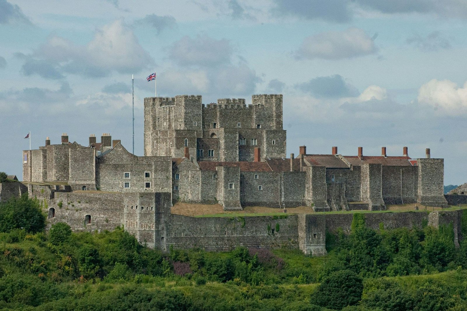 Dover Castle on the hill above green slopes