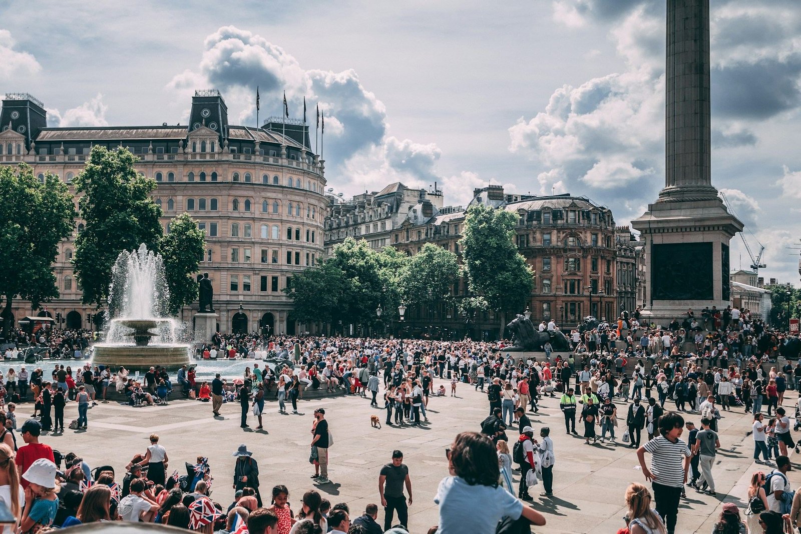 Crowds in Trafalgar Square on a cloudy day