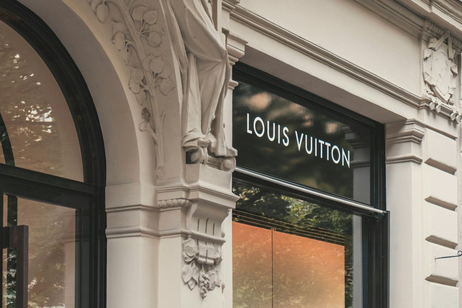 Louis Vuitton store entrance with an ornate stone arch